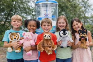 5 kids infront of our stuffing machine holding their new buddies